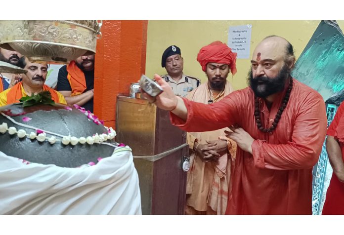 Mahant Deependra Giri Ji and other devotees performing Puja at historic Shankaracharya temple, Srinagar on Sunday. -Excelsior/Shakeel