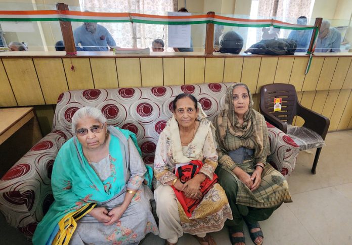 Elderly pensioners waiting for their turn for physical verification at a treasury in Jammu. -Excelsior/Rakesh