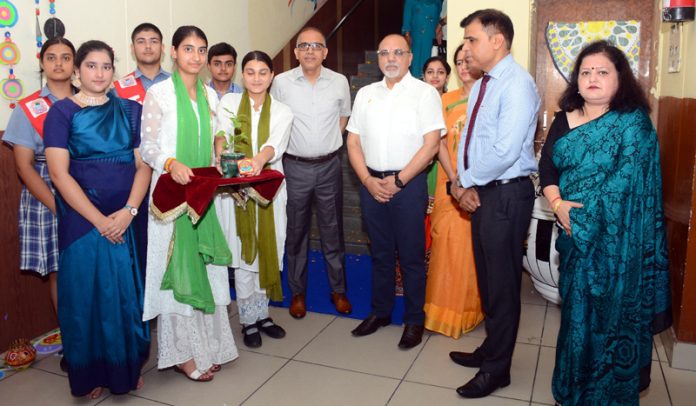 Sunil Kumar, ADC Bhaderwah posing along with students and school management.