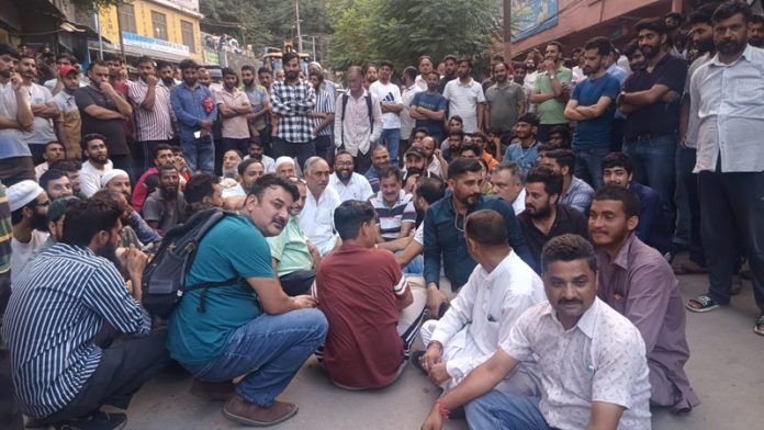 Locals of Maitra, Ramban during a protest against the opening of liquor shop.