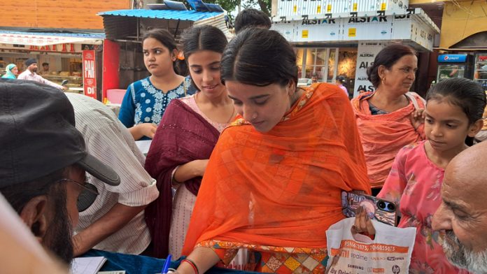 A girl puts her signature during a campaign by DADAA in R.S Pura on Tuesday.