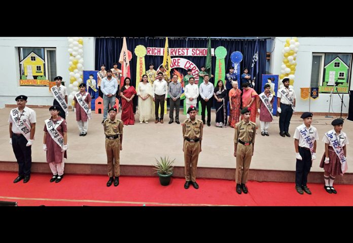 Newly elected students council of Rich Harvest School posing along with dignitaries.