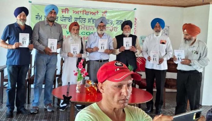 Dignitaries releasing Punjabi novel 'Adam Te Hawa' by Bhupider Singh Raina in Srinagar.