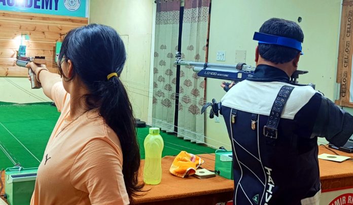 Shooters aiming at target during District Rifle Shooting Championship at Jammu.