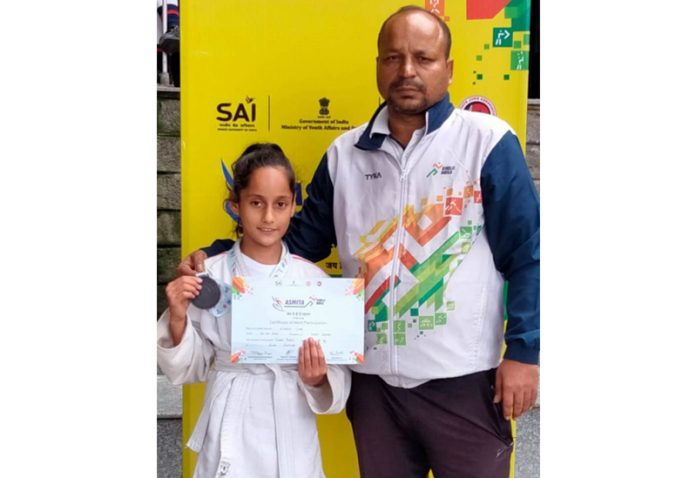 Arya Chib of J&K, who won a bronze medal in Sub Junior Category of Judo Tournament in the ongoing Khelo India Women League at Shimla, posing alongwith her Instructor Manish Chatwal.