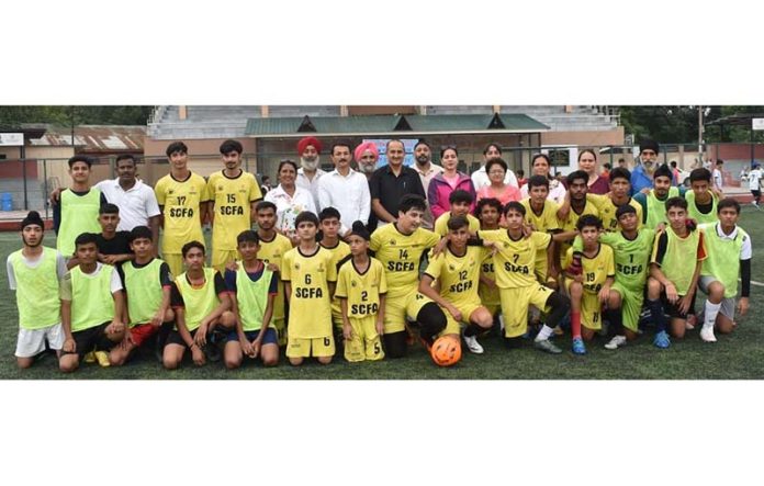 Dignitaries posing along with young footballers in Jammu.