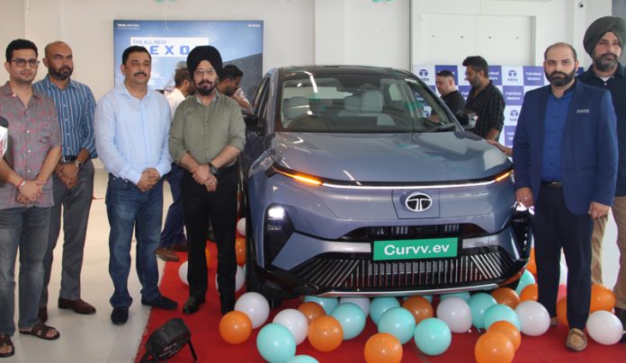 Transport Commissioner, Rajinder Singh Tara and others posing with Tata Curvv EV after unveiling it at Fairdeal Motors Jammu. —Excelsior/Rakesh