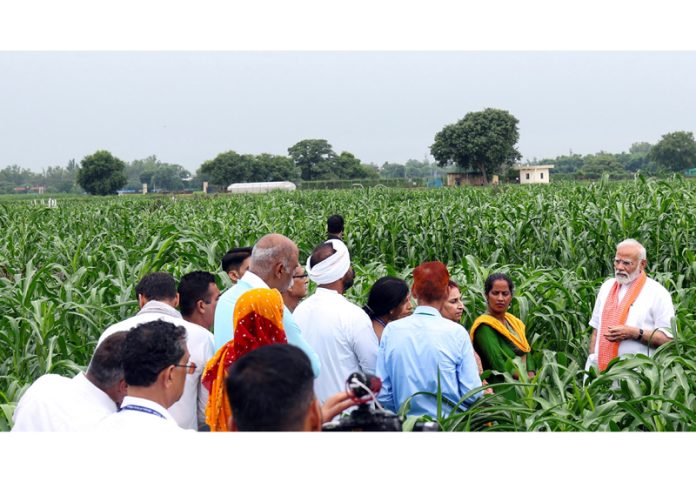 Prime Minister Narendra Modi interacts with the farmers and scientists at India Agricultural Research Institute, in New Delhi on Sunday. (UNI)