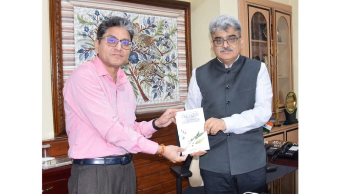 Author Vishal Sharma presenting his maiden book to CS Atal Dulloo on Thursday.