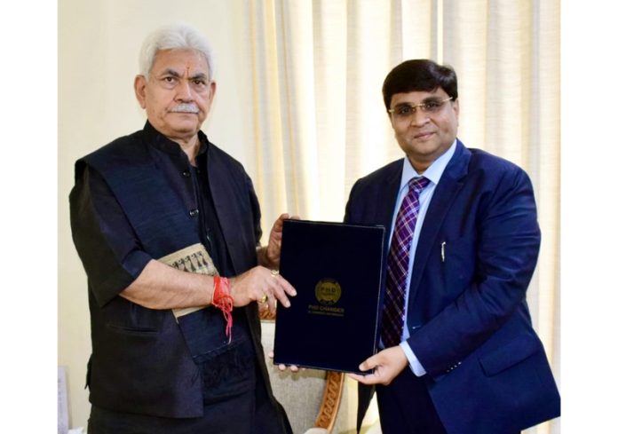 Chairman PHDCCI, Jammu Chapter, Rahul Sahai hands over a memorandum to LG Manoj Sinha.