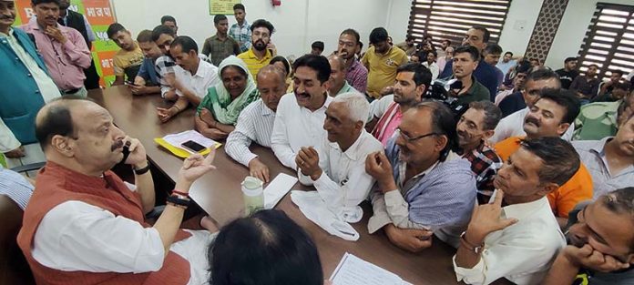 BJP senior leader Devender Singh Rana listening public grievances at Party Headquarter on Friday.