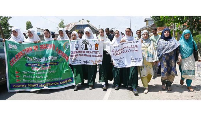 Students campaigning to sensitize people about importance of sanitation in Srinagar on Friday.