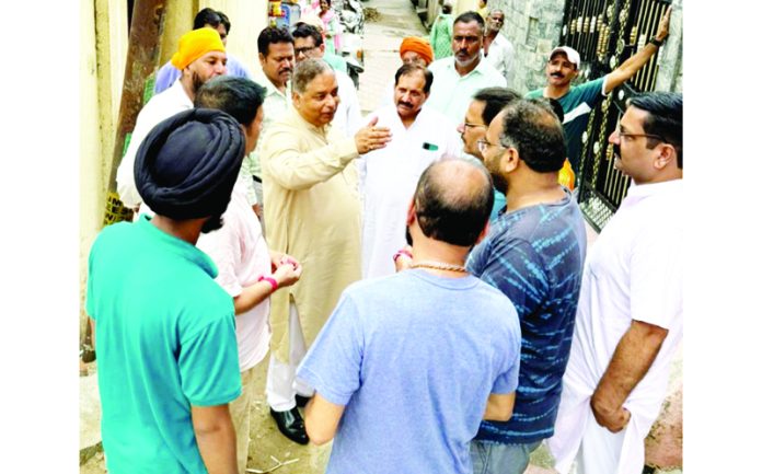 Sat Sharma, former J&K BJP President interacting with the people in Canal Road area of Jammu on Monday.