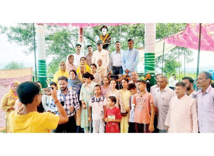 People paying their tribute to Shaheed Mohinder Singh in Billawar on Monday.