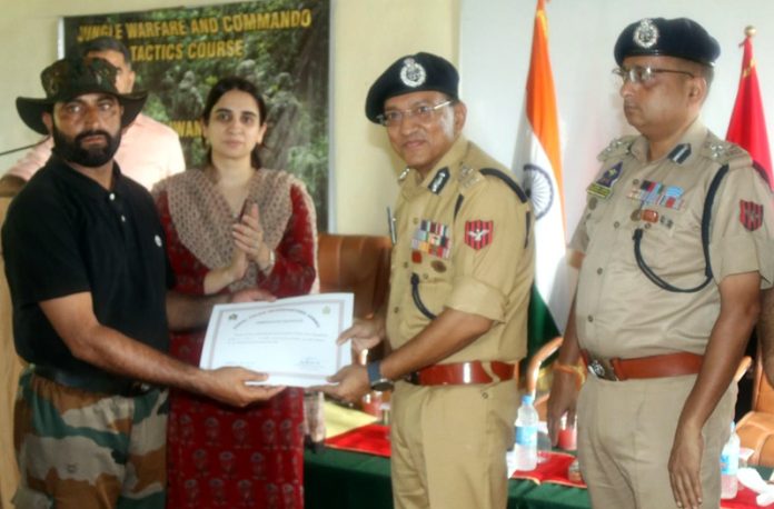 ADGP Jammu, Anand Jain, awarding a Drill Instructor with a Commendation Certificate at CTC Sunjwan on Saturday.