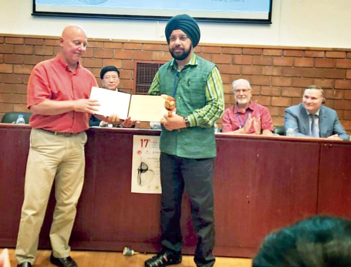 Prof Jasbir Singh receiving award from Prof Stavros Mavroundeas during 17th Forum held at Panteion University, Athens, Greece.