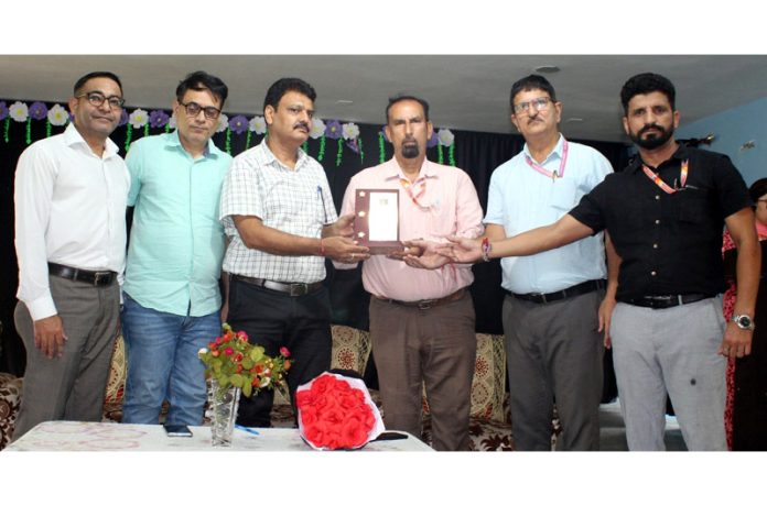 Humanity Public School management presenting memento to dignitary.