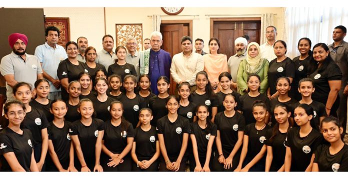 Lieutenant Governor Manoj Sinha posing along with officials, coaches and Gymnasts at Raj Bhawan in Srinagar.