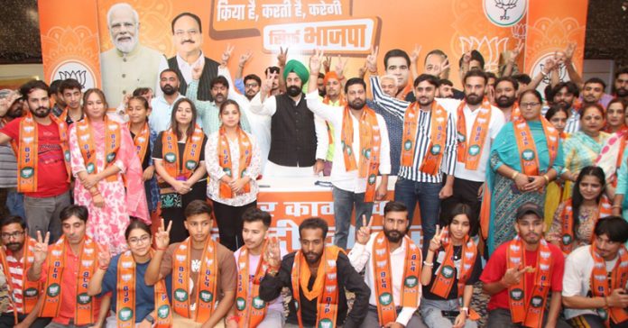 BJP National Spokesperson, RP Singh along with social worker Anil Kumar and his supporters posing for a group photograph.