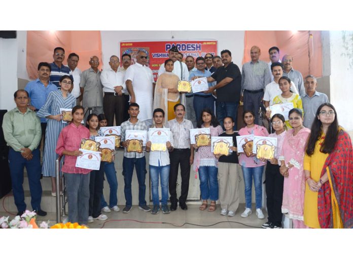 Students and others posing for a photograph at Vishwakarma Sabha during a felicitation function in Jammu on Sunday.