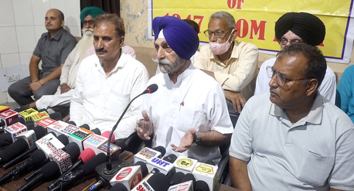 JKSAC president Gurdev Singh addressing press conference at Press Club in Jammu on Monday. -Excelsior/Rakesh