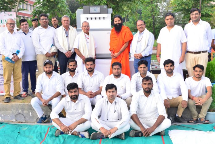 Swami Ramdev and Acharya Balkrishna with scientists of Patanjali Yogpeeth while unveiling soil testing machine 'Dharti Ka Doctor'.