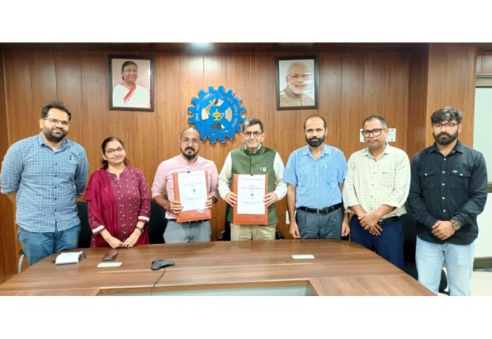 Director of CSIR-IIIM Jammu displaying copy of MoU for value addition of aroma crops.