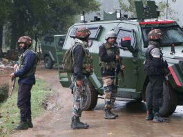 Security forces take position near the encounter site at Adigam Devsar village of Kulgam district on Saturday. -Excelsior/Sajjad Dar