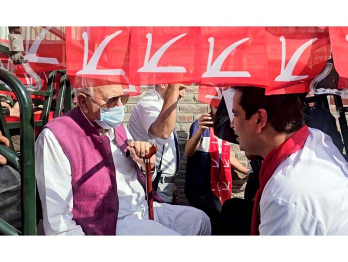 NC president Dr Farooq Abdullah campaigning in an auto rickshaw for the party’s Zadibal segment candidate Tanvir Sadiq in Srinagar on Sunday. -Excelsior/Shakeel