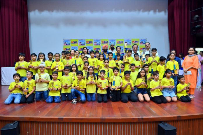 Students of various UCMAS centers posing along with trophies during prize distribution ceremony.