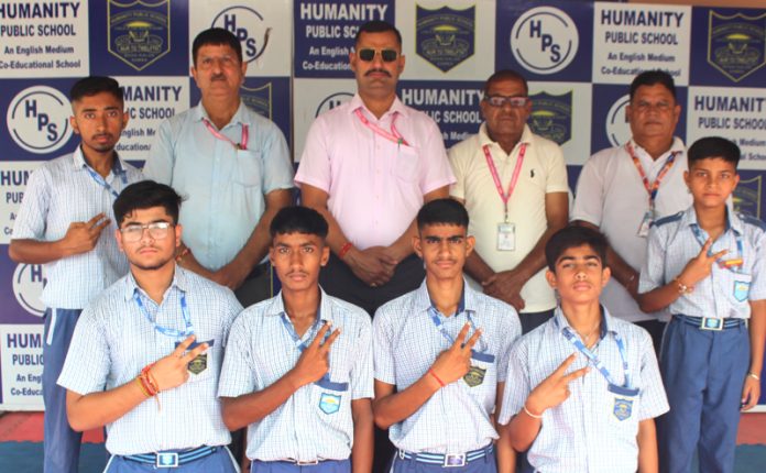 Students posing along with school management.