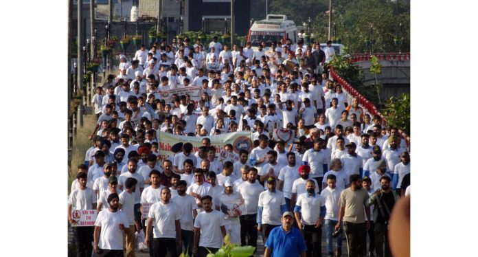 Hundreds of people passing through Bikram Chowk flyover during a walkathon at Jammu on Sunday.