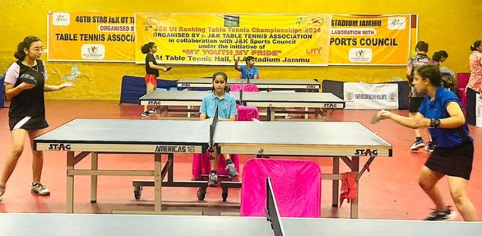 Table Tennis players in action during a match at MA Stadium Jammu.