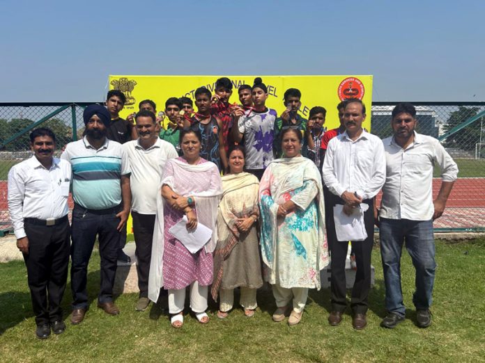 Winners posing with medals and dignitaries during Athletic meet at Jammu University.