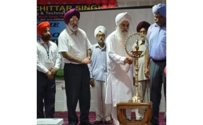 Mahant Manjit Singh lighting traditional lamp during a programme.