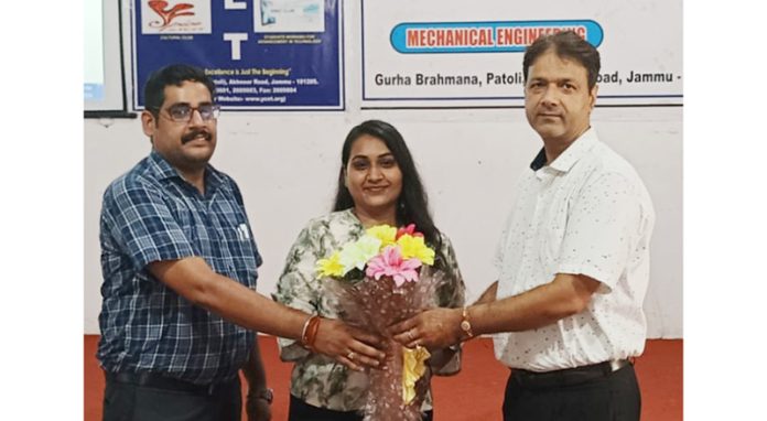 Chief Guest receiving bouquet during a programme.