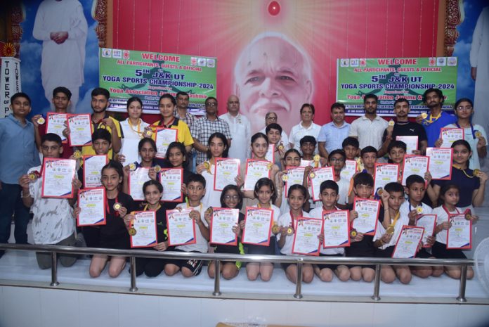 Youngsters posing along with certificates during Yoga Sports Championship at Jammu.