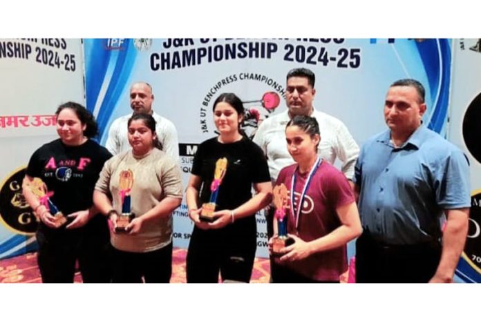 Powerlifters posing with trophies during J&K UT Bench Press Championship at Jammu.