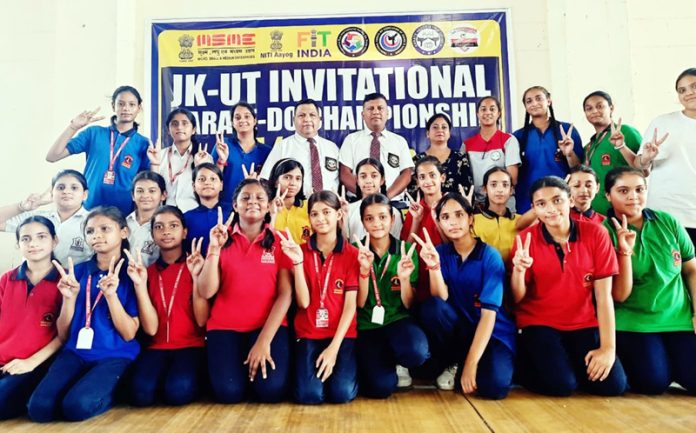 Karate players posing during Invitational Karate-Do Championship with dignitaries.