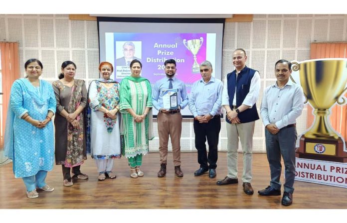 Dignitaries posing along with college management during a programme.