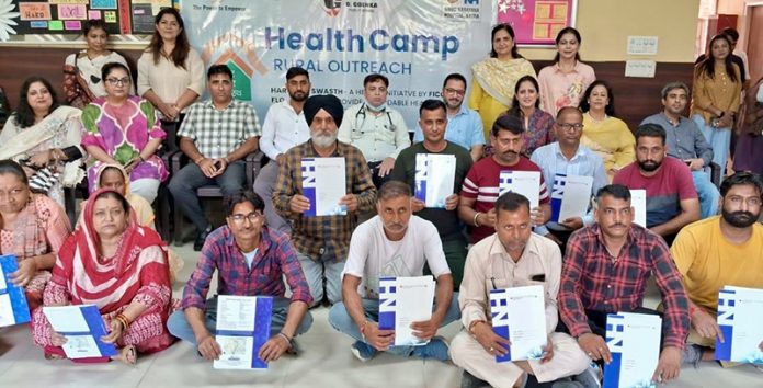 Beneficiaries posing along with officials of FICCI FLO JKL and Doctors of SMVD Narayana Super Speciality Hospital during health camp.