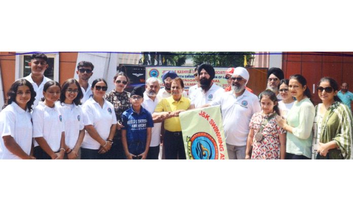 Swimmers along with dignitaries posing during flag off ceremony outside the MA Stadium, Jammu.