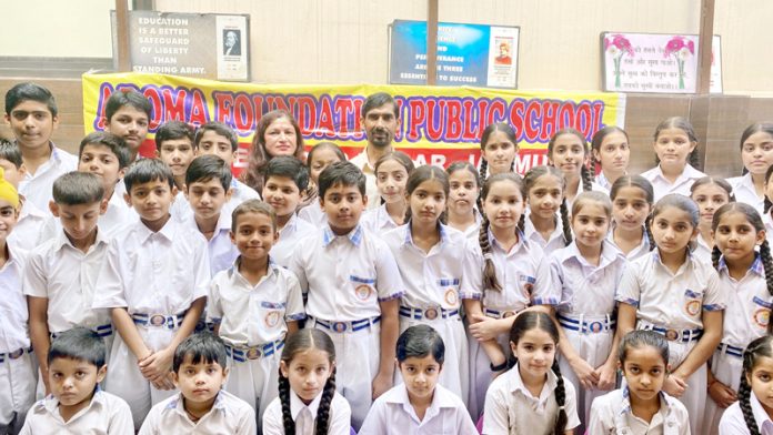 Students along with dignitaries posing during painting competition.