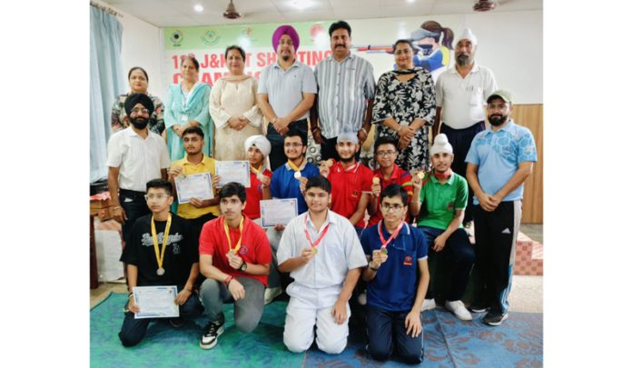 Players posing for group photograph with dignitaries during an event at Jammu.