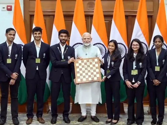 PM Narendra Modi posing with players of 45th Chess Olympiad at New Delhi on Wednesday.