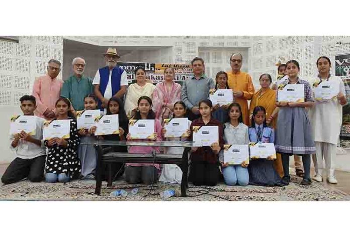 Students along with others posing with certificates they received at a function organised by Vomedh in Jammu on Thursday.