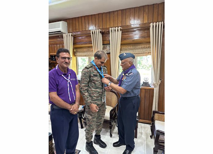 National Commissioner of Scouts & Guides fixing tie of Scouts & Guides on GOC Tiger Division on Thursday.