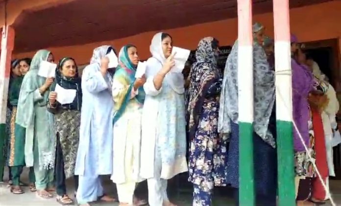 Voters standing in long queue at a polling station in border area of Nowshera. -Excelsior/Imran