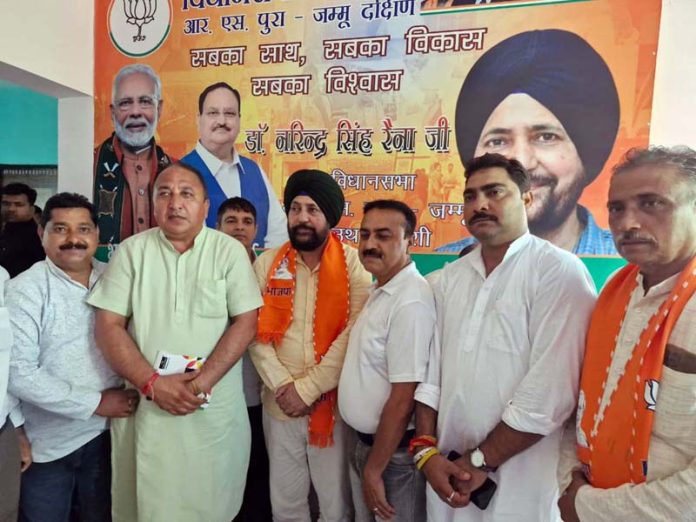 BJP candidate from RS Pura Jammu South constituency posing with other party leaders.