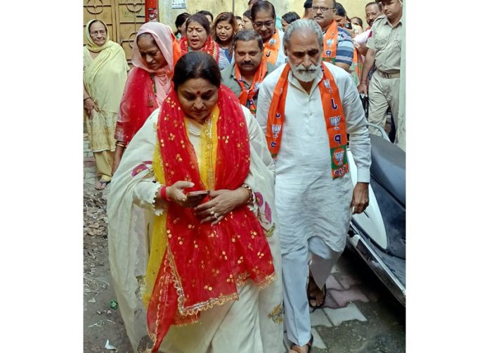 Former Minister, Priya Sethi during a door to door campaign in Jammu East on Sunday.